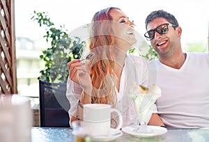 Young couple enjoying coffee at a street cafe