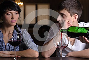 Young couple enjoying a glass of wine at the bar