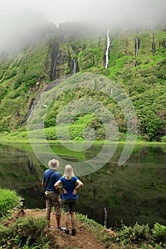 Young couple enjoying the landscape of the waterfall in Pozo da Alagoinha. photo