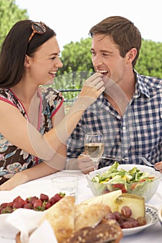 Young Couple Enjoying Outdoor Meal Together