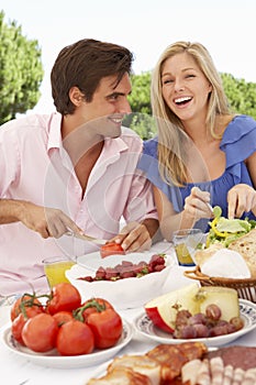 Young Couple Enjoying Outdoor Meal Together