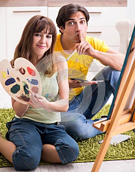 Young couple enjoying painting at home