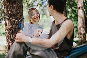 Young couple enjoying a peaceful moment in a hammock at the park