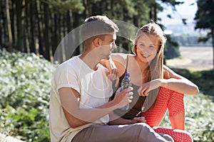 Young Couple Enjoying Picnic In Countryside