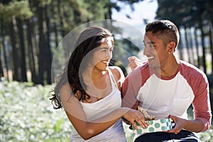 Young Couple Enjoying Picnic In Countryside