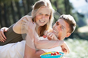 Young Couple Enjoying Picnic In Countryside