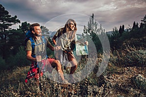 Couple enjoying on their hiking trip, walking up the mountain trail