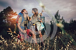 Couple enjoying on their hiking trip, walking up the mountain trail