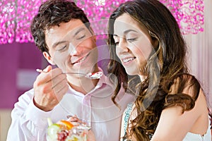 Young couple enjoying their time in ice cream parlor