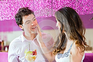 Young couple enjoying their time in ice cream parlor photo
