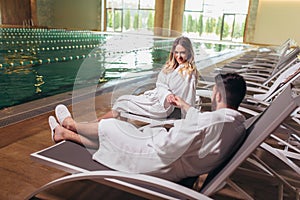 Young couple enjoying treatments and relaxing at wellness spa center