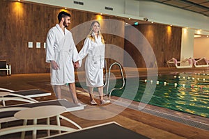 Young couple enjoying treatments and relaxing at wellness spa center