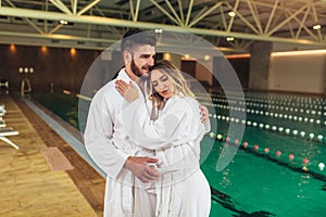 Young couple enjoying treatments and relaxing at wellness spa center