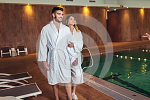 Young couple enjoying treatments and relaxing at wellness spa center