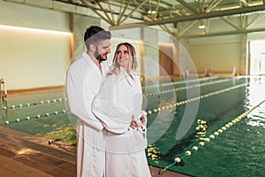 Young couple enjoying treatments and relaxing at wellness spa center