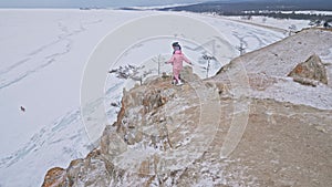 Young couple enjoying walking outdoors in winter top mountains. Active couple walking on through winter time, beautiful