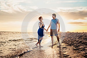 A young couple enjoys a mid summer late afternoon, on a wet san