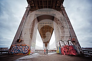 Young couple in the evening under the bridge