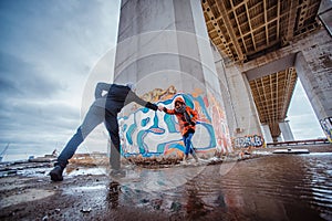 Young couple in the evening under the bridge