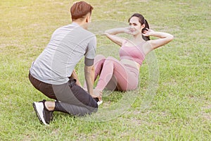 Young couple exercising at the city park
