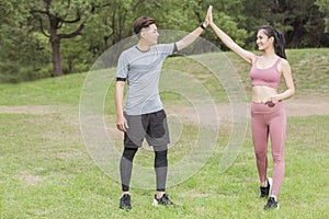 Young couple exercising at the city park