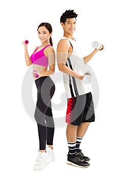 Young couple exercising with dumbbell