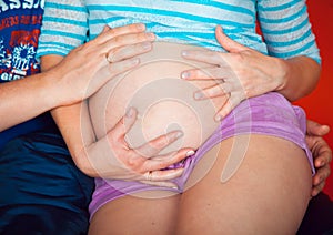 Young couple expecting a baby lying on the couch while enjoying the moment. childbirth