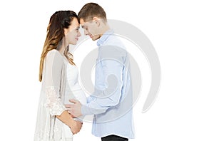 Young couple expecting baby standing together isolated on white background - baby born photo
