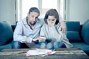 Young Couple Feeling sad and stressed paying bills debts mortgage having financial problems