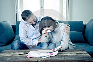 Young Couple Feeling sad and stressed paying bills debts mortgage having financial problems