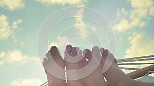 Young couple feet rest in hammock on the sky background in slwomotion. 1920x1080. hd