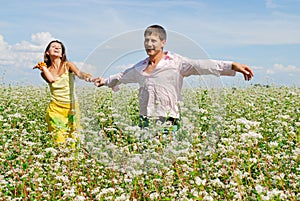 Young couple on field of flowers