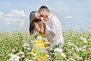 Young couple on field of flowers