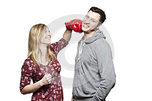 Young couple fighting with boxing gloves smiling