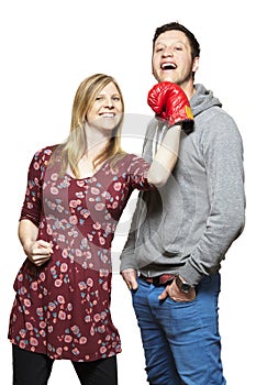 Young couple fighting with boxing gloves smiling