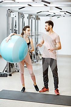 Young couple with fitness ballls at the gym photo