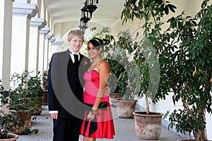 Young Couple in formal attire peeking out