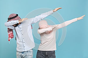 Young couple friends arabian muslim man wonam in keffiyeh kafiya ring igal agal hijab clothes isolated on blue wall