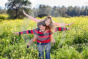 Young couple frolicking in the countryside.