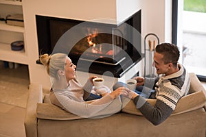 Young couple in front of fireplace