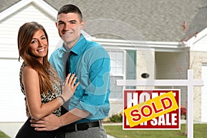 Young Couple In Front of New Home