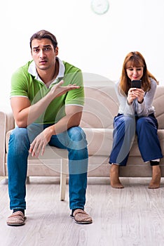 Young couple in gadget dependency concept