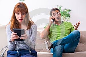 Young couple in gadget dependency concept