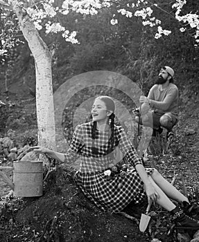 Young Couple gardening in the garden. I like spending time on farm. Country life. Two people gardening in the backyard