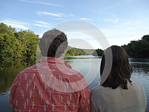 Young Couple Gazing Upstream as the Sun Sets