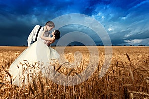 Young couple getting married in wheat field