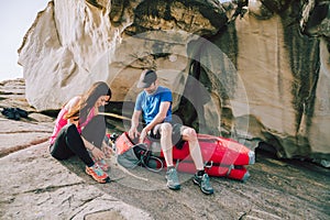 Young couple getting ready for climbing