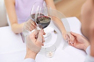 Young couple with glasses of wine at restaurant