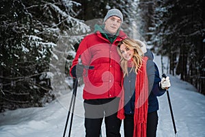 A young couple got out of the city into the woods to go skiing