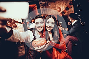 Young Couple in Halloween Costumes taking Selfie